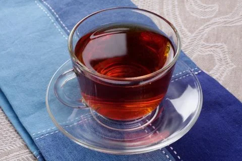 Cup of hot tea on a dark blue napkin Stock Photos