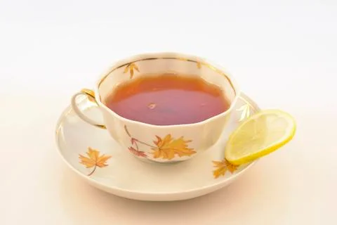 A cup of hot tea with lemon Stock Photos
