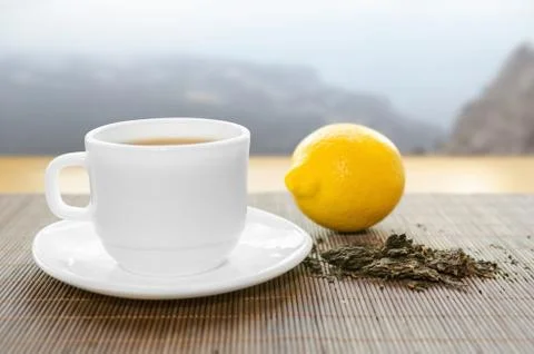 Cup of hot tea with lemon Stock Photos