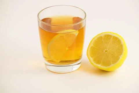 Cup of hot tea with lemon slice on a white background. Glass of ice tea with Stock Photos