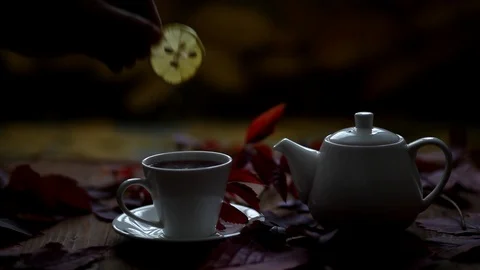 In a cup of hot tea put a slice of lemon. Stock Footage 120425951