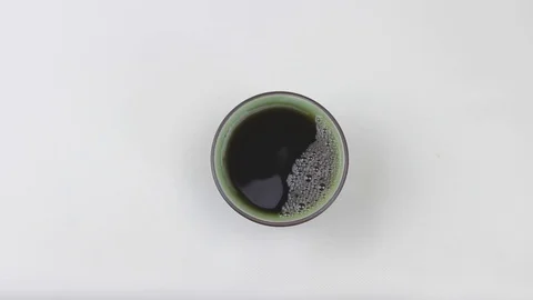 A cup of hot tea stands motionless. Morning tea. Green cup with tea Stock Footage 127835604