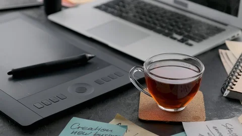 Cup of hot tea stands at a workplace Vídeo Stock 128538885