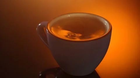 Cup of hot tea with steam on shiny background Stock Footage 65752729