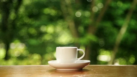 Cup of hot tea at window side abstract blur background. Stock Footage 98637690