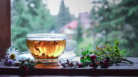A cup of hot tea on a windowsill Stock Footage