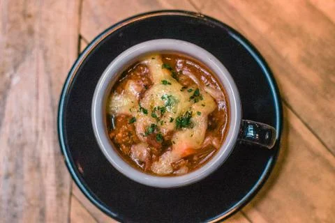 Cup of House Made Beef Chilli with cheese on top Stock Photos