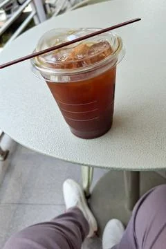 A cup of iced coffee on a table Foto stock