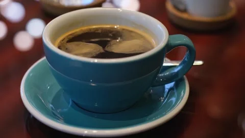 A cup of invigorating freshly brewed coffee on the table, close-up Stock Footage 244949027