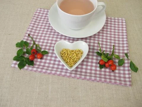 A cup of kernels tea from rose hip seeds Stock Photos