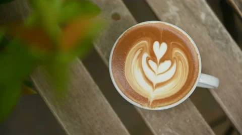 A cup of latte art coffee on table Stock Footage 41301293