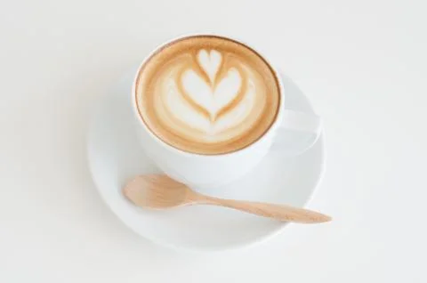 A cup of latte art on white background Stock Photos