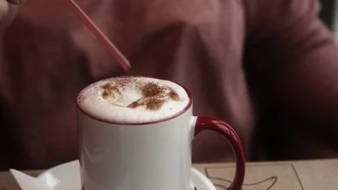 A cup of latte coffee with a straw Stock Footage 76727626