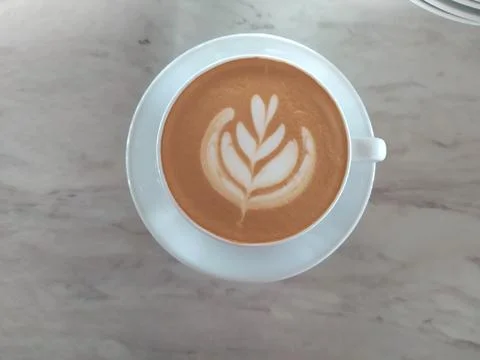 A cup of latte on table flat view Stock Photos