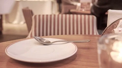 A cup of latte on table with people sitting and walking.Coffee shop cafe Vídeo Stock 84720877