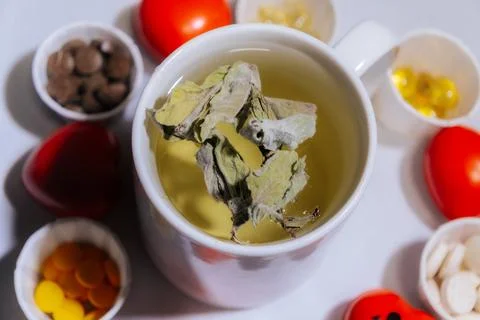 A cup of light peppermint herbal tea with dried leaves. Stock Photos
