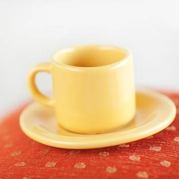 Cup lying on pillows on the bed Foto stock
