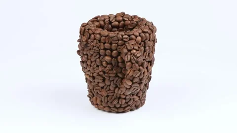 A cup made of coffee beans on white. Side view. Loop motion. Stock Footage 245078792