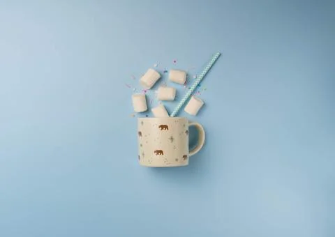 Cup with marshmallow on blue background Stock Photos