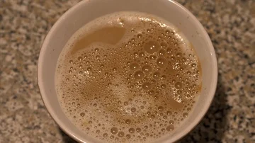 Cup of Milk and coffe with bubbles Stock Footage 85484260