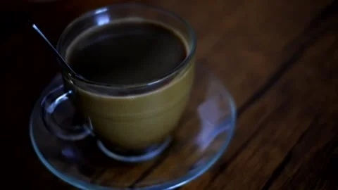 A cup of milk coffee on the table Stock Footage 241080719