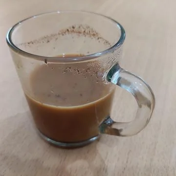A cup of milk coffee on the table Stock Photos