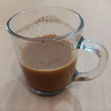 A cup of milk coffee on the table Stock Photos