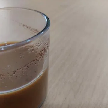 A cup of milk coffee on the table Stock Photos