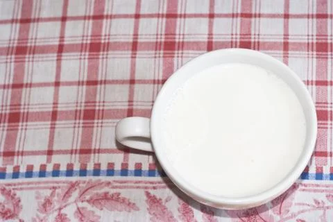 Cup of milk on the table Foto stock