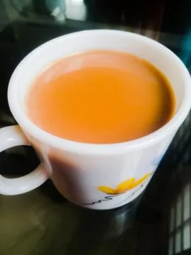 A Cup of milk tea placed in a table Stock Photos