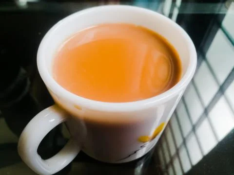 A Cup of milk tea placed in a table. Stock Photos