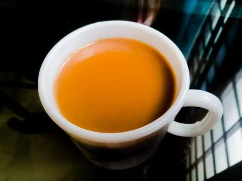 A Cup of milk tea placed in a table. Stock Photos