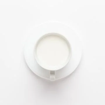 Cup of milk on white background Stock Photos