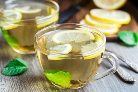 Cup with mint and lemon tea Stock Photos