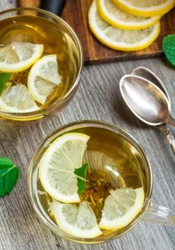 Cup with mint and lemon tea Stock Photos