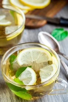 Cup with mint and lemon tea Stock Photos