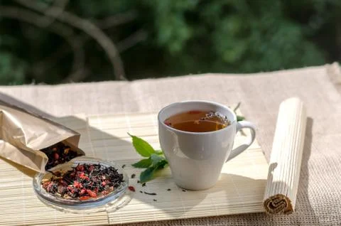 Cup of mint tea and a bunch of mint on the table Stock Photos