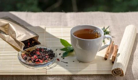 Cup of mint tea and a bunch of mint on the table Stock Photos