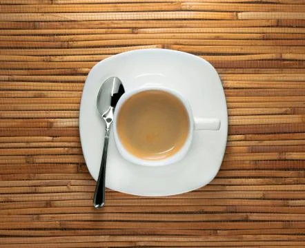 A cup of morning black espresso coffee on saucer and reed background Stock Photos