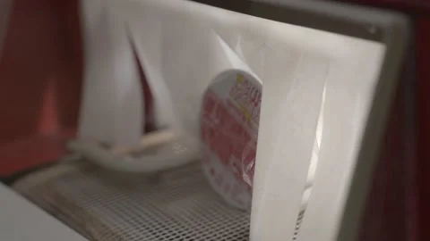 Cup noodle goes through heating conveyor belt Stock Footage 228756729