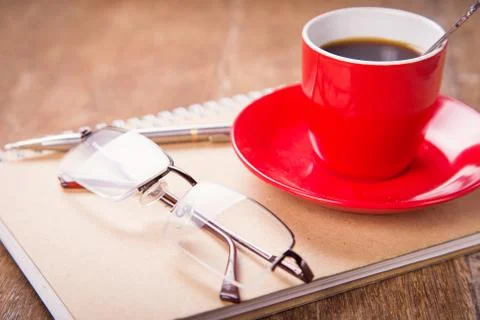 Cup with notebook Stock Photos