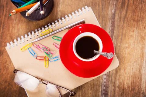 Cup with notebook Stock Photos