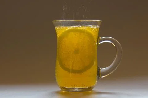 Cup with orange drink and lemon Stock Photos