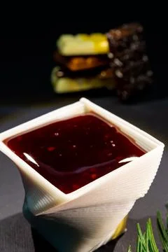 A cup printed with chocolate on a 3D printer with berry jam Foto stock