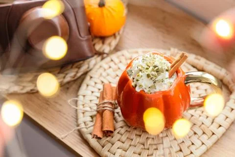 Cup of pumpkin latte with camera and cinnamon on table at home, closeup Stock Photos