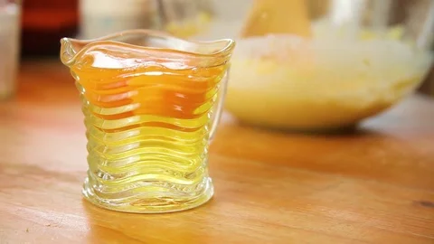 Cup of raw eggs kept next to the bowl with batter Stock Footage 76198214