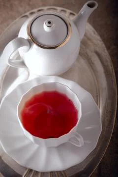 A cup of Red fruit tea with a kettle. Stock Photos