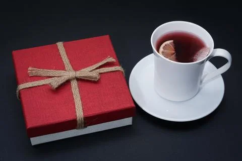 Cup of red tea with lemon slice, present on dark table Stock Photos