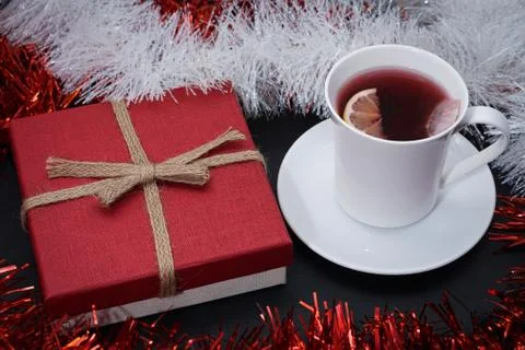 Cup of red tea with lemon slice, present on dark table Stock Photos
