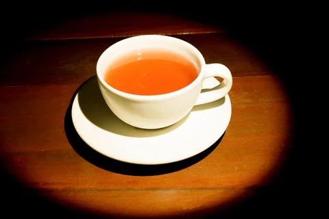 A cup of refreshing black tea, soft warm light for a morning meal, dark wood  Stock Photos